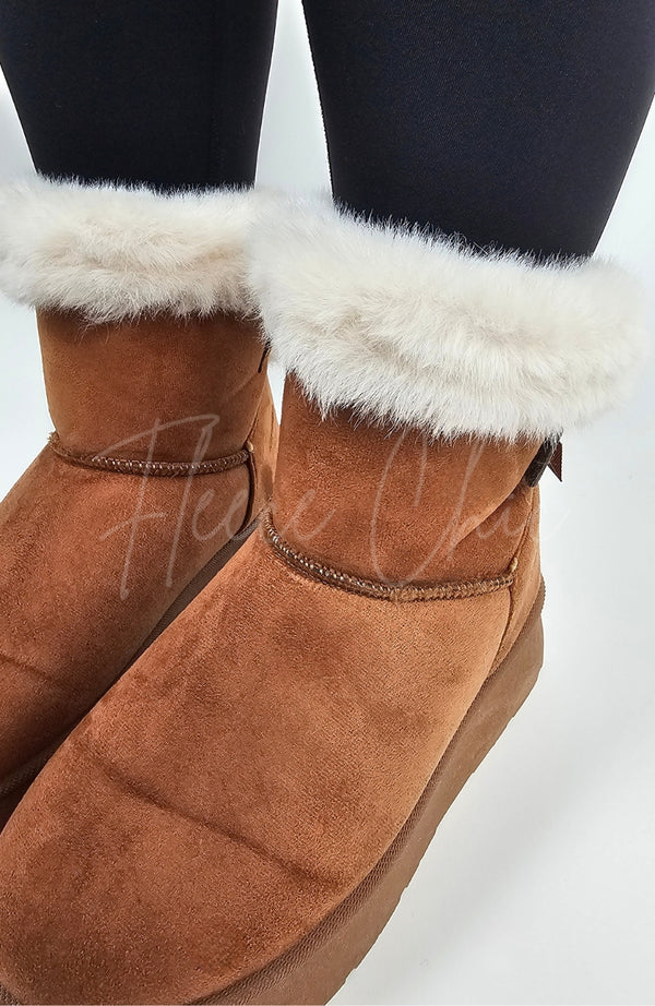 A close-up detail shot of the fur trim on a pair of winter boots by Fleece Chic.