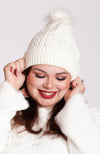 A woman wears a white fleece beanie by Fleece Chic.