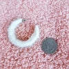 A medium hoop earring is displayed next to a quarter for a size reference - Fleece Chic