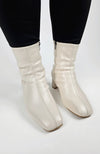 Leather Winter Boots that are cream-colored are worn by a woman in black leggings - Fleece Chic