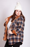 A woman wears a white fleece beanie paired with Fleece Chic's Flannel Jacket.