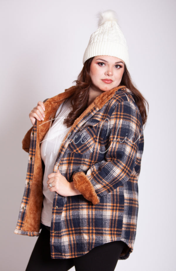 A woman wears a white fleece beanie paired with Fleece Chic's Flannel Jacket.