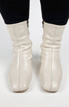 Cream-colored Leather Winter Boots are worn and posed in for a close-up shot - Fleece Chic