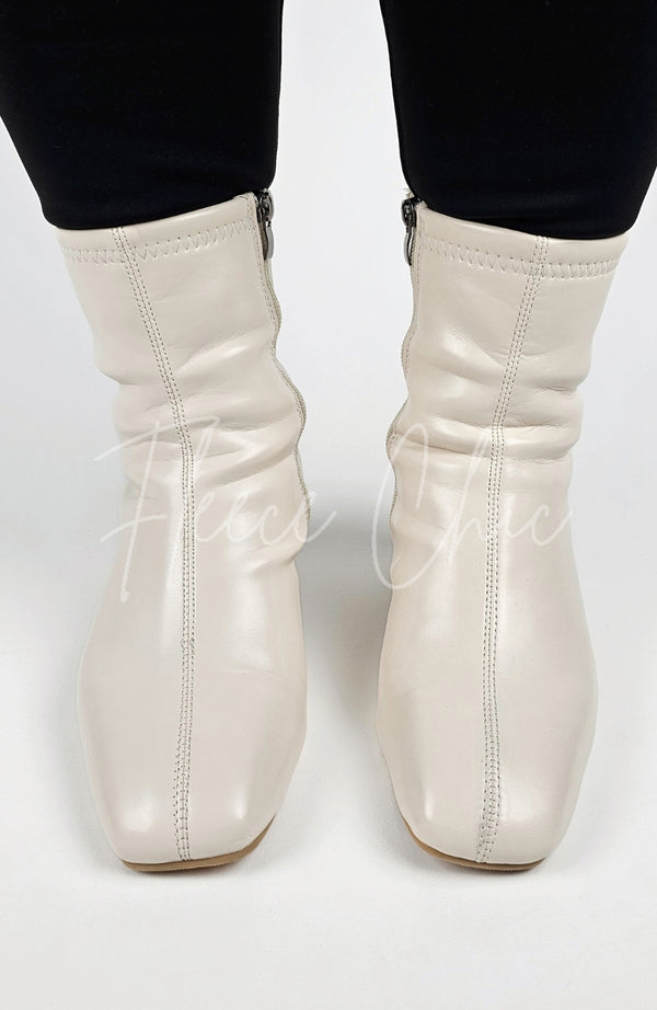 Cream-colored Leather Winter Boots are worn and posed in for a close-up shot - Fleece Chic