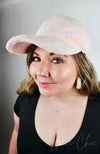 A woman wearing a pink Fur Baseball Cap by Fleece Chic.