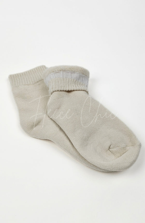 A pair of beige quarter socks on a white background with one turned inside out a little to show off its plush interior - Fleece Chic