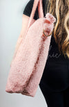 A side view of a pink shearling zippered tote bag by Fleece Chic.