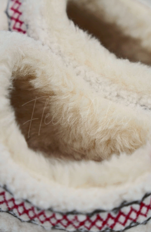 A close up of a pair of teddy platform slippers by Fleece Chic.