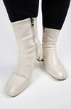 Cream-colored Leather Winter Boots are worn and posed in for a close-up shot - Fleece Chic