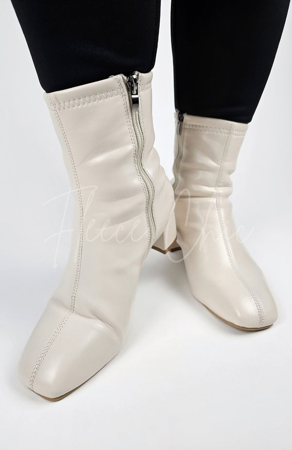 Cream-colored Leather Winter Boots are worn and posed in for a close-up shot - Fleece Chic