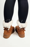 White fur trim and a back bow decorate a cute pair of winter boots by Fleece Chic.