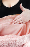 A woman shows off the inside pockets of a shearling zippered tote bag by Fleece Chic.