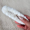 The underside detail of a white fluffy claw hair clip by Fleece Chic.