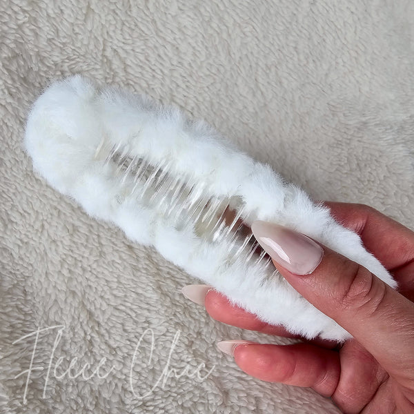The underside detail of a white fluffy claw hair clip by Fleece Chic.