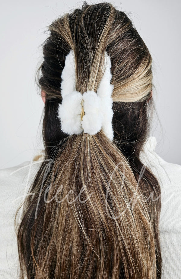 A claw hair clip that is fluffy and white is used in a half updo on a woman's brown long hair - Fleece Chic