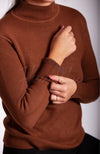 A cotton sweater that is brown has its plush lining displayed for the camera - Fleece Chic