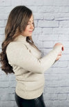 A woman poses in a cotton sweater and thermal leather leggings - Fleece Chic