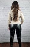 A woman poses in a cotton sweater and thermal leather leggings showing the rear view of the outfit - Fleece Chic