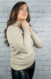 A woman poses in a cotton sweater and thermal leather leggings - Fleece Chic