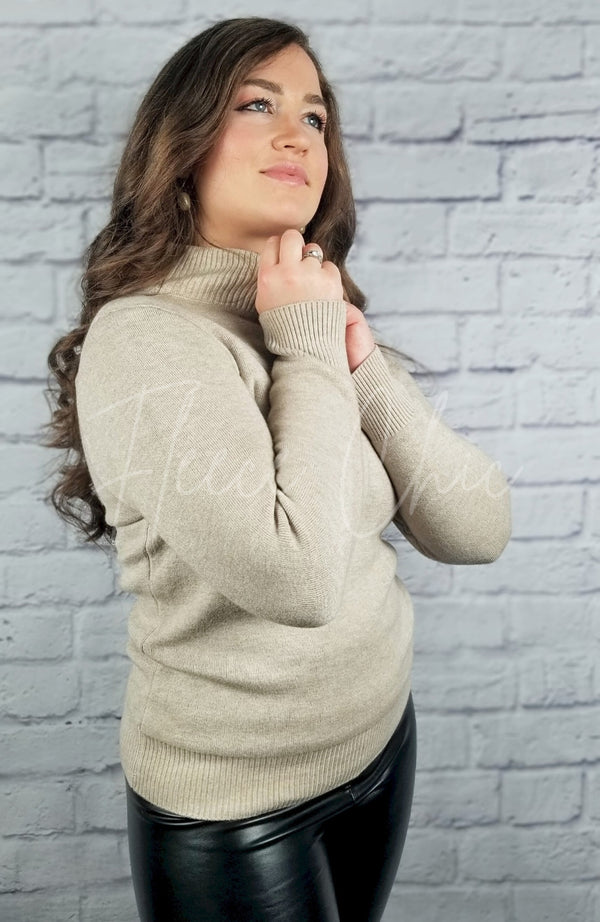 A woman poses in a cotton sweater and thermal leather leggings - Fleece Chic