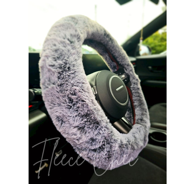 A close up detail shot of a Fuzzy Steering Wheel Cover that is black with gray tips to look like real fur - Fleece Chic