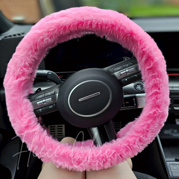 A close up detail shot of a pink steering wheel cover that looks like real fur - Fleece Chic