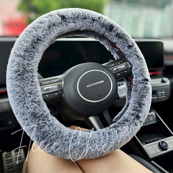 A close up detail shot of a Fuzzy Steering Wheel Cover that is black with light gray tips to look like real fur - Fleece Chic