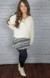 Fleece lined tights that are black with a fuzzy lining are worn with a skirt, white sweater, and white boots - Fleece Chic