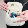 A fur purse is open and has products in it to show how much it can carry - Fleece Chic