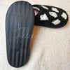 The tread of a pair of fuzzy slippers with ghosts on them is visible for the camera - Fleece Chic