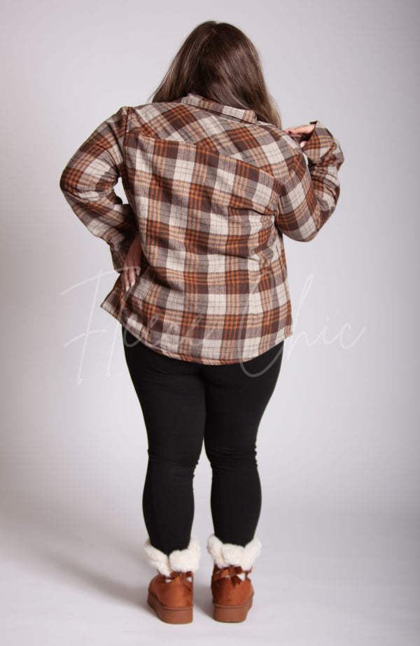 A woman poses showing off the rear view of a Lined Flannel Shirt Jacket that is brown, winter leggings, and brown fur lined winter boots - Fleece Chic