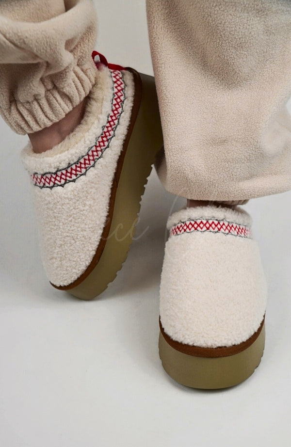 Curly Tasman platform slippers by Fleece Chic that are white.