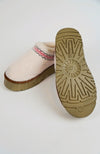 A pair of white teddy platform slippers showing their side view and underside - Fleece Chic