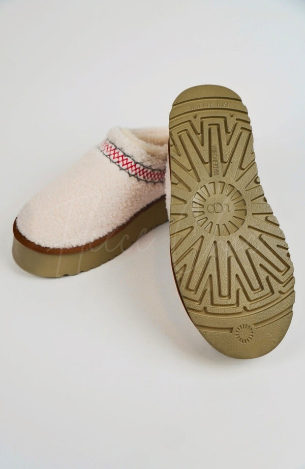 A pair of white teddy platform slippers showing their side view and underside - Fleece Chic