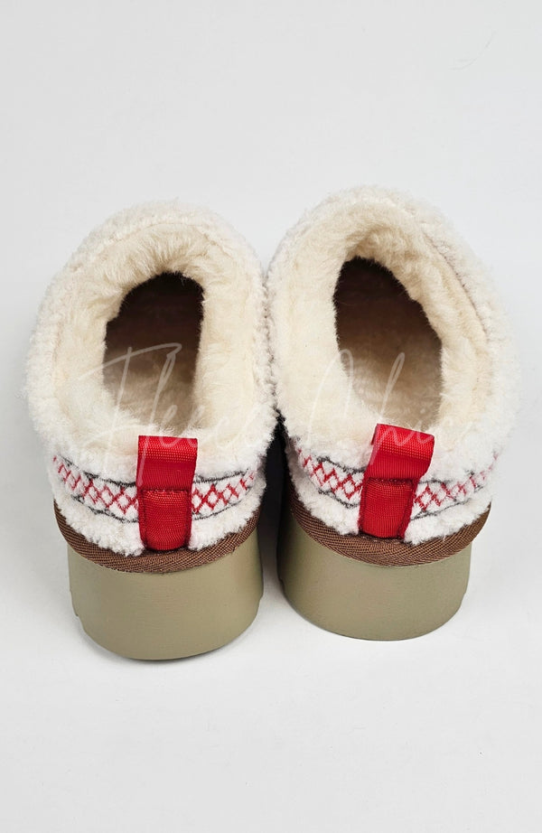 The backside of a pair of teddy platform slippers by Fleece Chic.