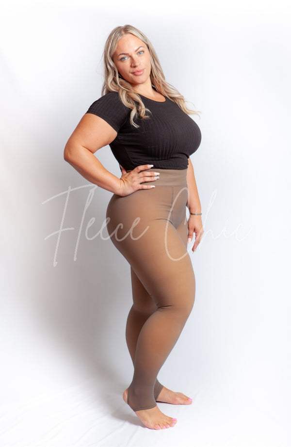 Plus size tights with a fleece lining in the stirrup style are worn with a black crop top - Fleece Chic