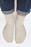 Beige quarter socks worn with rolled-up jeans on a white background - Fleece Chic