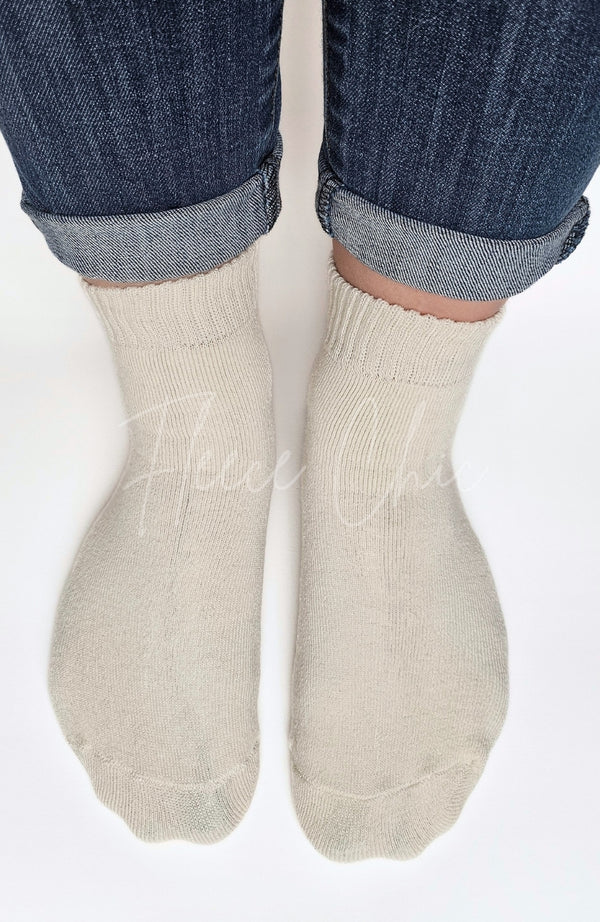 Beige quarter socks worn with rolled-up jeans on a white background - Fleece Chic