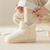 A woman wears a pair of thick socks inside of plush slippers - Fleece Chic
