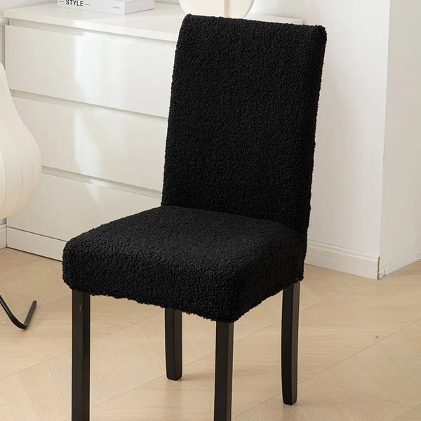 A sherpa chair cover that is black, providing a plush and cozy appearance while adding protection - Fleece Chic