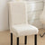 A white sherpa chair cover on a chair, providing a plush and cozy appearance while adding protection - Fleece Chic