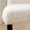 A detail shot of a white sherpa chair cover on a chair, providing a plush and cozy appearance while adding protection - Fleece Chic
