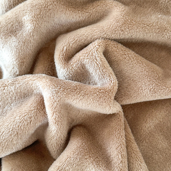 A plush blanket that is tan has a close-up to show its detail - Fleece Chic
