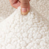A detail shot of a sherpa chair cover that is white by Fleece Chic.