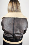 The backside of a brown faux shearling jacket by Fleece Chic.