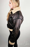 The profile view of a brown faux aviator styled shearling jacket by Fleece Chic.