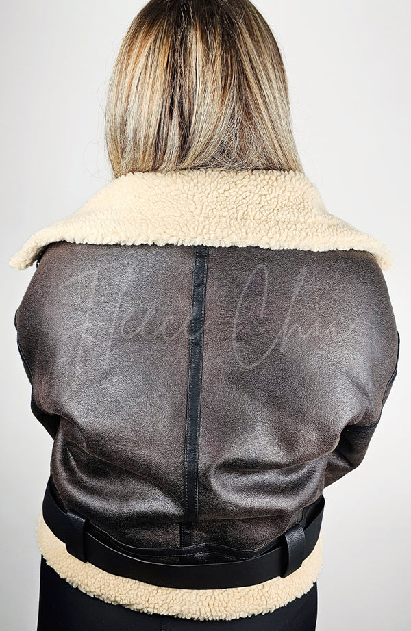 The backside of a brown faux shearling jacket by Fleece Chic.