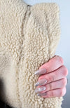 The fuzzy inside lining of a shearling jacket in the vintage bomber style by Fleece Chic.