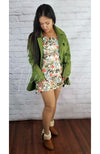 Plush tights that are light brown are worn by an Asian woman who is posing in a colorful dress, green pea coat, and fluffy winter boots - Fleece Chic