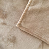 A plush blanket that is tan has a close-up to show its detail - Fleece Chic